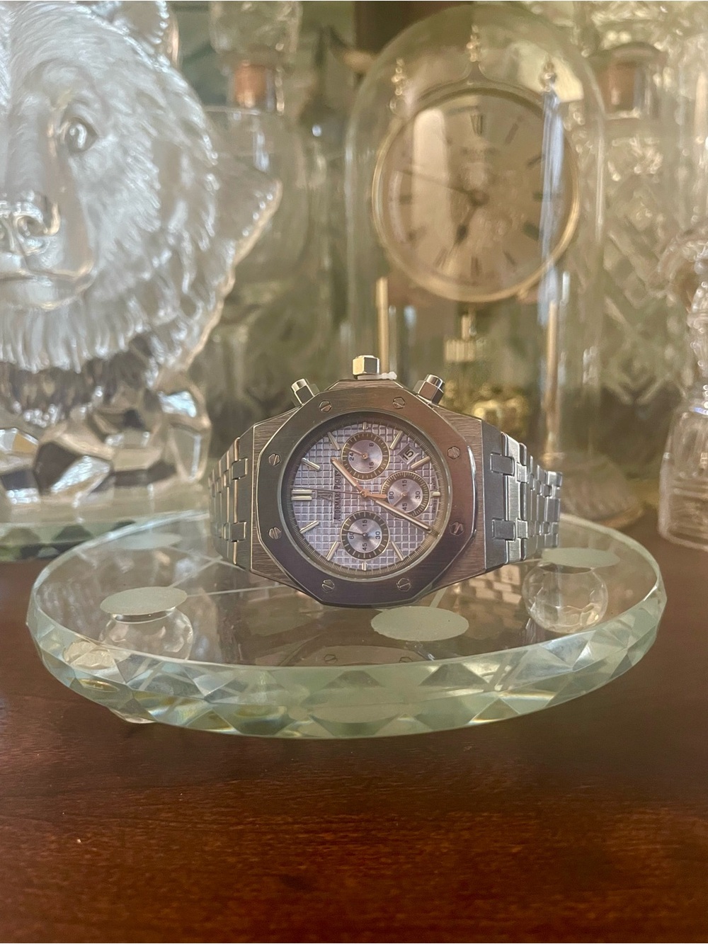 Men's watch with light-colored dial, tri-compass, and steel case.